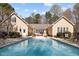Beautiful swimming pool with an iron fence surrounded by the home offering a private backyard oasis at 120 Teasel Ct, Clayton, NC 27527