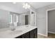 Modern bathroom with double sinks and a large mirror reflecting the shower and tub area at 127 S Harrison Place Ln, Fuquay Varina, NC 27526