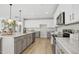 Modern kitchen with stainless steel appliances, a kitchen island with seating, and sleek cabinetry at 127 S Harrison Place Ln, Fuquay Varina, NC 27526