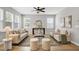 Bright living room features hardwood floors, modern furniture, and plenty of natural light at 127 S Harrison Place Ln, Fuquay Varina, NC 27526