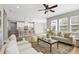 Open-concept living area with hardwood floors, modern decor, and a view of the kitchen island at 127 S Harrison Place Ln, Fuquay Varina, NC 27526