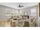 Inviting living area with stylish decor, hardwood floors, and ample natural light from large windows at 127 S Harrison Place Ln, Fuquay Varina, NC 27526