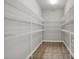 Walk-in pantry with custom shelving offering ample storage space at 127 S Harrison Place Ln, Fuquay Varina, NC 27526