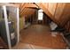 Unfinished attic space with exposed wood beams and water heater at 1309 Wakefield Farm Rd, Zebulon, NC 27597