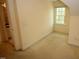 Attic featuring neutral-colored carpet, natural light, and an architectural window at 1309 Wakefield Farm Rd, Zebulon, NC 27597