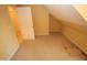 View of the attic featuring neutral-colored carpet, a closet, and an attached room at 1309 Wakefield Farm Rd, Zebulon, NC 27597