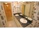 Bathroom featuring a double sink, white countertops, and decorative wallpaper and flooring at 1309 Wakefield Farm Rd, Zebulon, NC 27597
