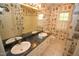 Bathroom featuring a double sink, white countertops, and decorative wallpaper and large mirror at 1309 Wakefield Farm Rd, Zebulon, NC 27597