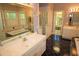 Bathroom featuring double vanities, mirrors, and bathtub at 1309 Wakefield Farm Rd, Zebulon, NC 27597