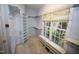 Walk-in closet offering lots of natural light and built-in shelving units and storage at 1309 Wakefield Farm Rd, Zebulon, NC 27597