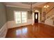 Charming dining room featuring wainscoting, windows, and chandeliers at 1309 Wakefield Farm Rd, Zebulon, NC 27597
