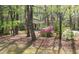Beautiful home nestled amongst mature trees with vibrant azaleas in the front yard at 1309 Wakefield Farm Rd, Zebulon, NC 27597