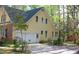 Exterior view of home featuring an attached garage and vibrant natural surroundings at 1309 Wakefield Farm Rd, Zebulon, NC 27597