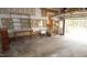 Spacious garage featuring utility sink, shelving, and access door at 1309 Wakefield Farm Rd, Zebulon, NC 27597