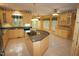 Bright kitchen with a large island, tile floors, and plenty of counter and cabinet space at 1309 Wakefield Farm Rd, Zebulon, NC 27597