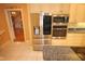 Kitchen with stainless steel refrigerator and ovens at 1309 Wakefield Farm Rd, Zebulon, NC 27597