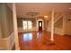 Spacious living room featuring hardwood floors, columns, and chandeliers at 1309 Wakefield Farm Rd, Zebulon, NC 27597