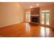 Open living room featuring a red brick fireplace and hardwood floors at 1309 Wakefield Farm Rd, Zebulon, NC 27597