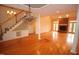 Spacious living room featuring hardwood floors, fireplace, and staircase at 1309 Wakefield Farm Rd, Zebulon, NC 27597