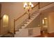 Staircase and foyer area featuring wood flooring, chandelier, and decorative wall sconces at 1309 Wakefield Farm Rd, Zebulon, NC 27597
