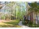 Spacious yard with mature trees, green grass, and a charming walkway leading to the house at 1309 Wakefield Farm Rd, Zebulon, NC 27597