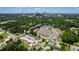 Panoramic aerial view of the neighborhood with tree coverage, townhomes, and the city skyline in the distance at 1317 Garner Rd # 101, Raleigh, NC 27610