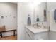 Clean bathroom design featuring a modern sink, a wooden bench and neutral colors at 1317 Garner Rd # 101, Raleigh, NC 27610