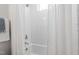 Bright, tiled bathroom with white tub and neutral color palette at 1317 Garner Rd # 101, Raleigh, NC 27610
