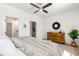 Bright bedroom showing doorways and a wooden dresser featuring a stylish mirror and plant at 1317 Garner Rd # 101, Raleigh, NC 27610