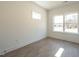 Well-lit bedroom with hardwood floors and a large window, offering a serene atmosphere at 1317 Garner Rd # 101, Raleigh, NC 27610
