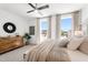 Well-lit bedroom boasting large windows, a ceiling fan, and stylish wooden dresser at 1317 Garner Rd # 101, Raleigh, NC 27610