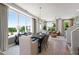 Open-concept dining room and living room with large windows, hardwood floors, and stylish modern furniture at 1317 Garner Rd # 101, Raleigh, NC 27610
