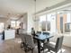 Open dining area with modern table and chairs, with natural light, seamlessly connected to the kitchen at 1317 Garner Rd # 101, Raleigh, NC 27610