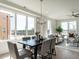 Sunlit dining room features a modern light fixture, a table for six, and large windows with scenic views at 1317 Garner Rd # 101, Raleigh, NC 27610