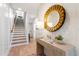 Inviting entryway with wooden staircase, patterned wallpaper, decorative mirror and table at 1317 Garner Rd # 101, Raleigh, NC 27610