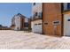 A modern townhome showing a garage and balcony, complemented by an attractive brick-paved parking area at 1317 Garner Rd # 101, Raleigh, NC 27610