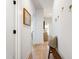 Bright hallway with light wood floors, white walls, and stylish decor at 1317 Garner Rd # 101, Raleigh, NC 27610