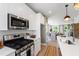 Gourmet kitchen with stainless steel appliances, white subway tile backsplash, quartz countertops, and ample storage space at 1317 Garner Rd # 101, Raleigh, NC 27610