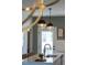 Contemporary kitchen island with a stainless steel sink, designer lighting, and an open view to the outdoor patio at 1317 Garner Rd # 101, Raleigh, NC 27610