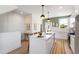 Bright modern kitchen with white cabinets, an island with sink, and stainless steel appliances at 1317 Garner Rd # 101, Raleigh, NC 27610