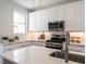 Modern kitchen with stainless steel appliances, undermount sink, white subway tile backsplash, and quartz countertops at 1317 Garner Rd # 101, Raleigh, NC 27610