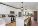 Bright kitchen with white cabinets, stainless steel appliances, and open floor plan at 1317 Garner Rd # 101, Raleigh, NC 27610