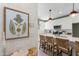 Modern kitchen with white cabinets, a white quartz island and stylish woven chairs at 1317 Garner Rd # 101, Raleigh, NC 27610
