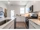 Modern kitchen with stainless steel appliances, undermount sink, white subway tile backsplash, and quartz countertops at 1317 Garner Rd # 101, Raleigh, NC 27610