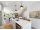 Open-concept kitchen featuring a white quartz island, stainless steel appliances, and breakfast bar at 1317 Garner Rd # 101, Raleigh, NC 27610