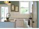 Bright kitchen featuring white cabinets, quartz countertops, stainless steel appliances and modern lighting at 1317 Garner Rd # 101, Raleigh, NC 27610