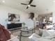 Elegant living room with modern decor, ceiling fan, and an open layout leading to the dining area and kitchen at 1317 Garner Rd # 101, Raleigh, NC 27610
