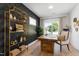Contemporary office space with large window, modern desk, and decorative shelving at 1317 Garner Rd # 101, Raleigh, NC 27610