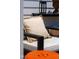 Cozy rooftop patio chair with pillow, black table, and an orange decorative stool at 1317 Garner Rd # 101, Raleigh, NC 27610
