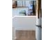 Bright staircase transitioning to the living room featuring hardwood floors and a cozy ottoman at 1317 Garner Rd # 101, Raleigh, NC 27610